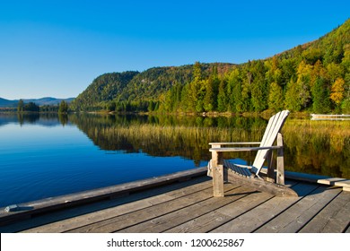 Wooden chair on lakeside pier