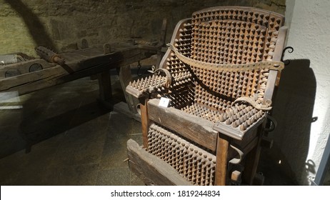 Wooden chair of torture displayed in a museum of medieval justice                              