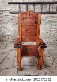 Wooden chair of torture displayed in a museum.