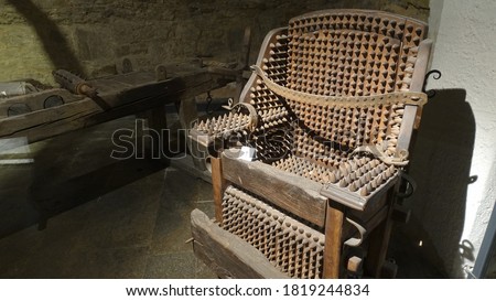 Wooden chair of torture displayed in a museum of medieval justice                              