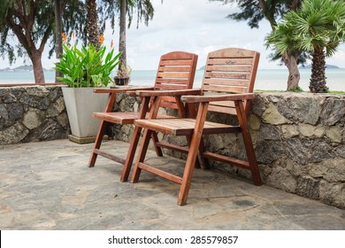 Wooden Chairs On Stone Terrace Beach In Summer