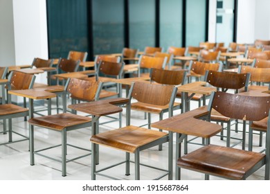 Wooden chairs are well arranged in the classroom. Empty classroom with vintage tone wooden chairs. Back to school concept.	