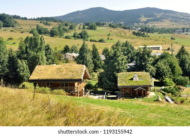 Wooden Chalet With A Roof With Grass In A Village In The Pyrenees Seen From The Little Yellow Train