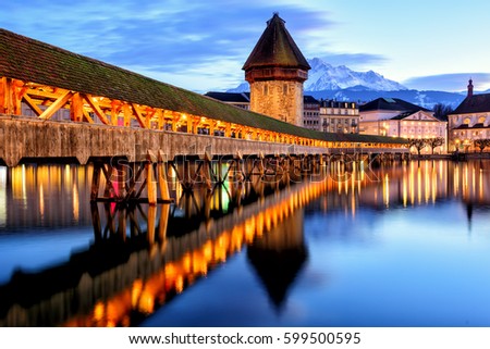 Wooden Chapel Bridge, Water Tower and Mount Pilatus in the Old Town of Lucerne, Switzerland, in the late evening light