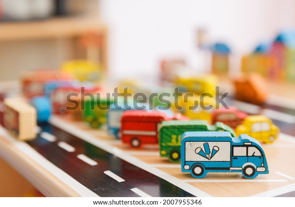 wooden children\'s toy truck with ice cream\
school bus on the background of the\
city