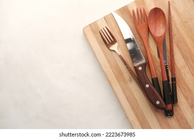 Wooden Chopping Board On Black Background Top Down 