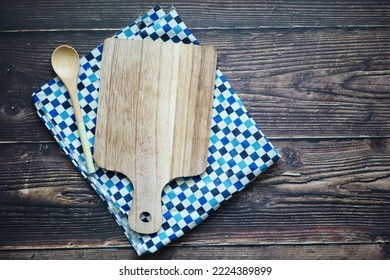 Wooden Chopping Board On Black Background Top Down 