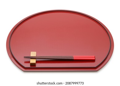 Wooden chopsticks on red lacquer tray with chopstick rest, Isolated on white background
