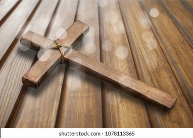 Wooden Christian cross on a table - Shutterstock ID 1078113365
