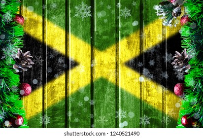 Wooden Christmas background with blurred flag of Jamaica. There is a place for your text in the photo.