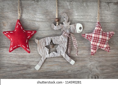 Wooden christmas deer and red stars on wooden background - Powered by Shutterstock