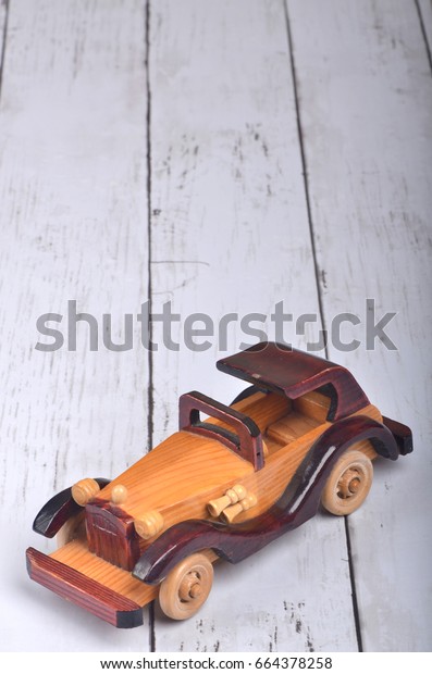 Wooden classical car\
on  wood background 
