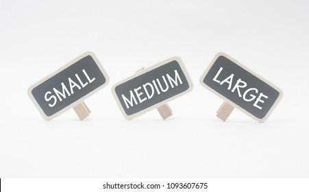 Wooden Clips Written Small,medium And Large Isolated On White Background.size Concepts.