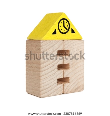 Wooden clock tower made of building blocks isolated on white. Educational toy for motor skills development
