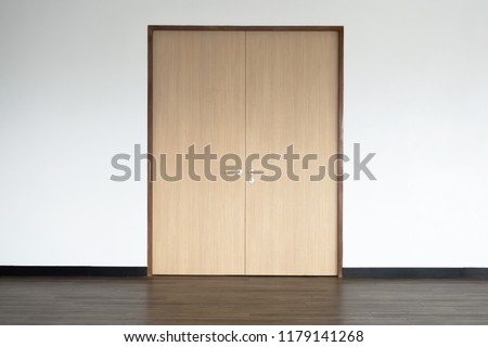 Wooden Closed  door on a clean wall indoors