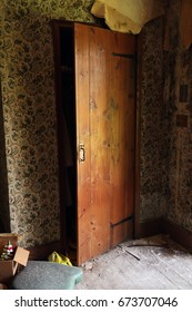 Wooden Closet Door Partially Open. Natural Light. 