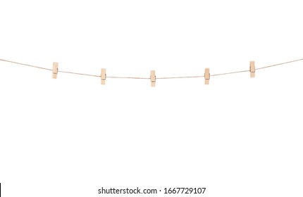 Wooden clothes pins hanging on brown rope  isolated on white background
