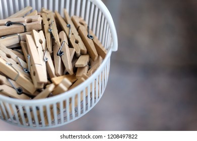 Wooden clothespins in the basket, blur, bright photo. The concept of eco-consumption, the use of natural materials, awareness.