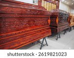 wooden coffins with a traditional Asian ornament pattern in a store in a funeral home in Asia in Vietnam
