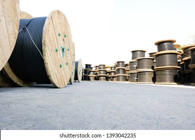 Wooden Coils Of Electric Cable Outdoor. High and low voltage cables in the storage.
