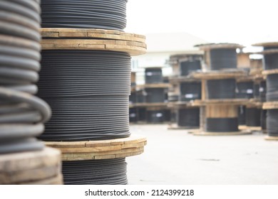 Wooden Coils Of Electric Cable Outdoor. High and low voltage cables in the storage. - Shutterstock ID 2124399218