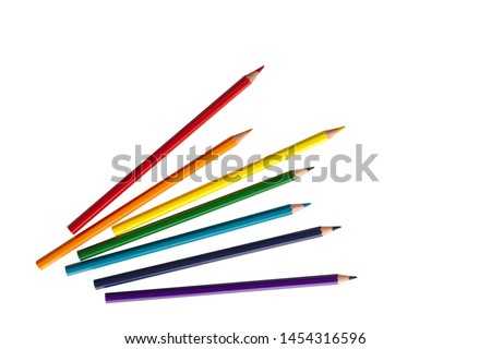 wooden color pencils arranged in bulk on a white isolated background