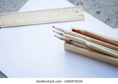 Wooden Colored pencils and ruler on white paper in nature concept