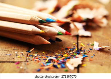 Wooden colorful pencils with sharpening shavings, on wooden table - Powered by Shutterstock