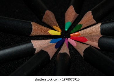 Wooden colorpencils on a black backgrounde photo