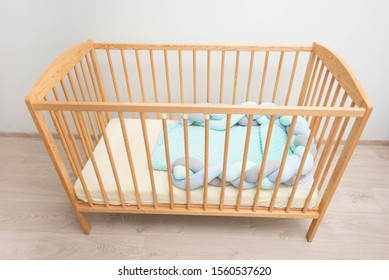 A wooden cot in a baby room