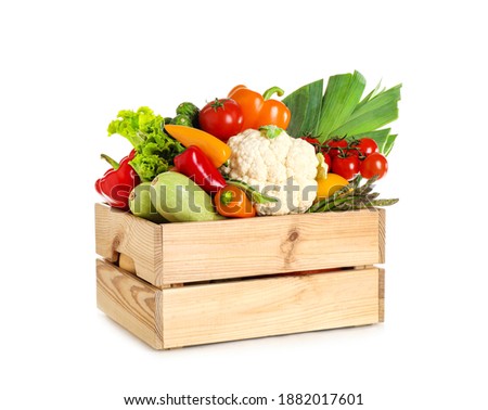 Wooden crate with fresh vegetables on white background