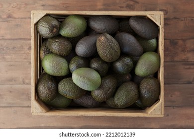 wooden crate full of avocados - Shutterstock ID 2212012139