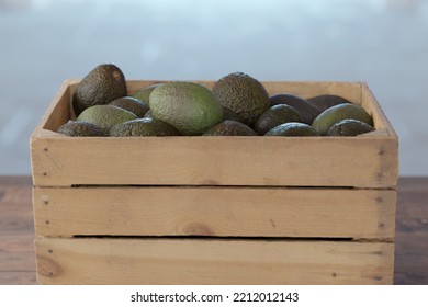 wooden crate full of avocados - Shutterstock ID 2212012143