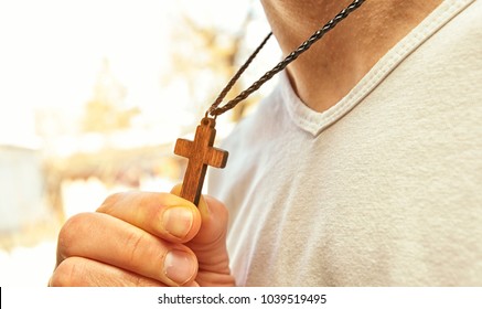 The Wooden Cross Necklace On Man's Neck