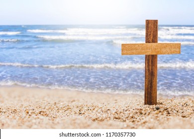 Wooden Cross On Beach With Blurred Seascape Background, Christian Concept Show God's Love Wide And Deep Like The Sea 