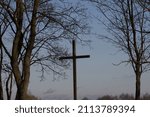 Wooden cross on the old cementary in winter. Concept for death and passing time.