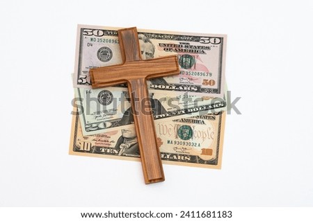 Wooden cross on US dollar banknotes