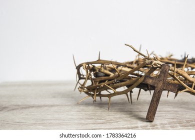wooden cross on wood table - Shutterstock ID 1783364216