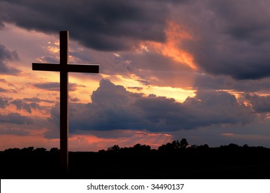 Wooden cross over a sunset - Shutterstock ID 34490137