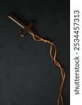 Wooden Cross Pendant with Leather Cord on Dark Background