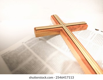 A wooden cross is placed on an open Bible, highlighting a scene of faith and devotion. The focus on the cross emphasizes its symbolic significance in Christianity. - Powered by Shutterstock