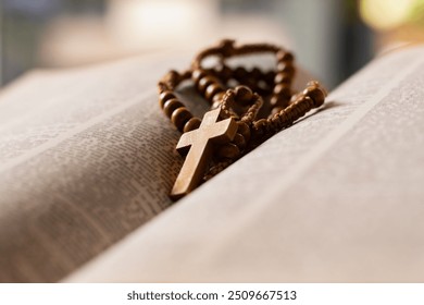 Wooden cross placed on opened page book, soft focus, concept for bible study of christanity priests.  - Powered by Shutterstock