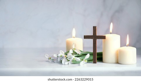 Wooden cross, snowdrops flowers and candles on table, blurred abstract background. Religious church holiday. symbol of faith in God, Christianity Feast, Easter, Palm Sunday, Lent - Shutterstock ID 2263229015