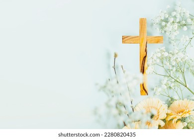 Wooden cross with spring flowers on blue background with copy space. Religion background. Religious church holidays. Christianity Feast, Easter, Palm Sunday, Christening, church wedding. Flat lay - Shutterstock ID 2280820435