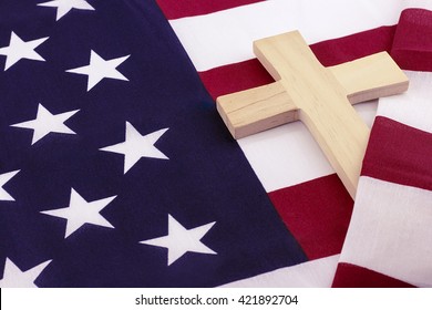 Wooden cross wrapped in American flag