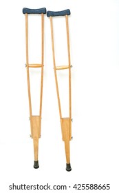 Wooden Crutches Rest On White Wall