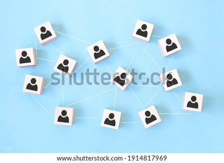 Wooden cube block print screen person icon which link connection network for organisation structure social network and teamwork concept.