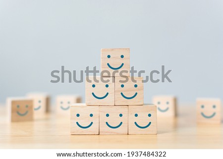 Wooden cube block shape with icon face smiley, The best excellent business services rating customer experience, Satisfaction survey concept