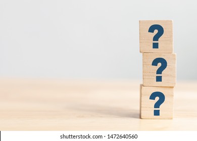 Wooden cube block shape with sign question mark symbol on wood table - Shutterstock ID 1472640560
