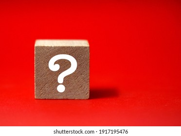 Wooden cube block shape with sign question mark symbol on red background - Shutterstock ID 1917195476